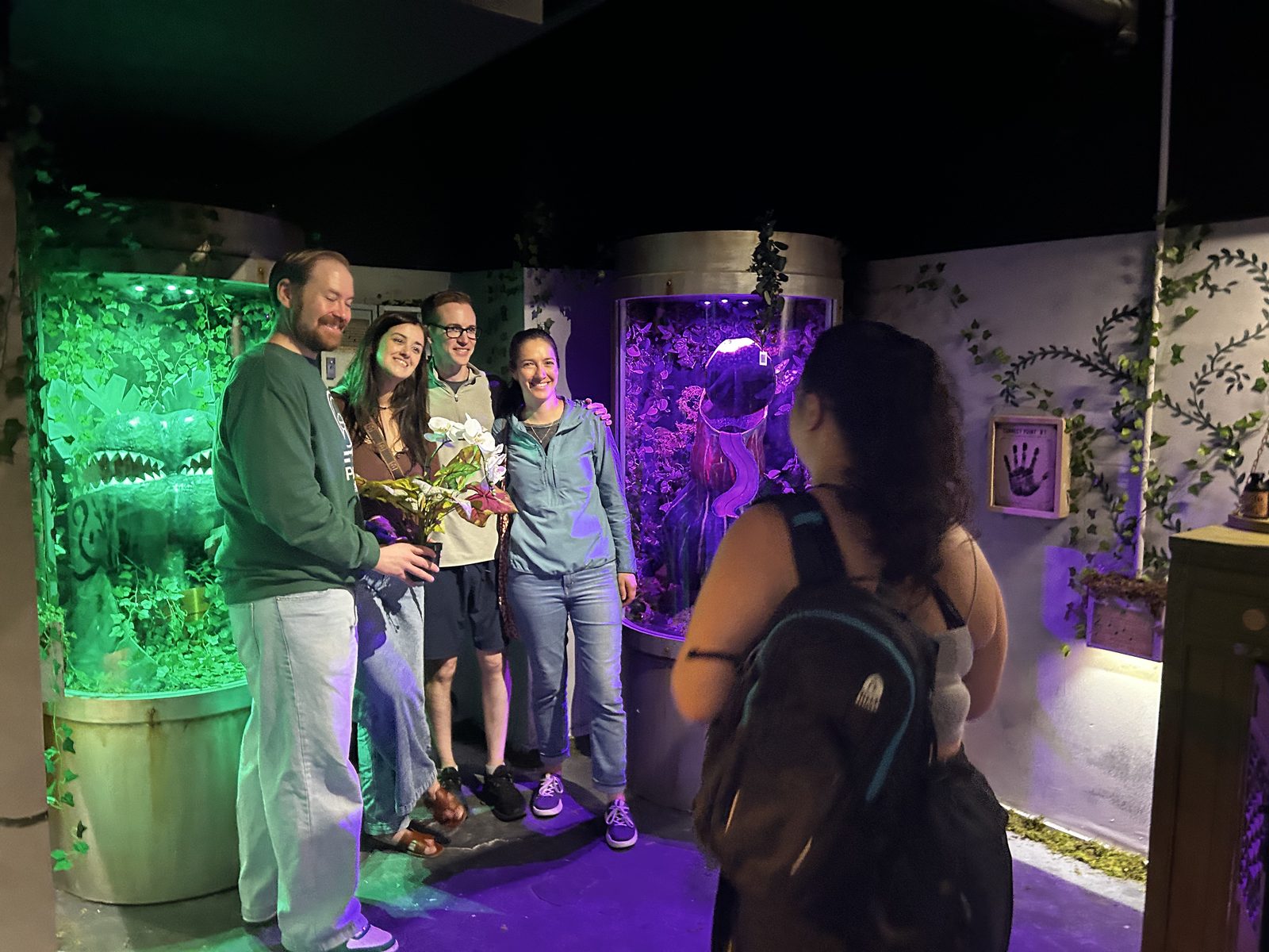 Beta testers celebrating together inside the Little Greenhouse of Horrors escape room in Philadelphia